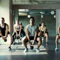 People working out with kettlebells at gym